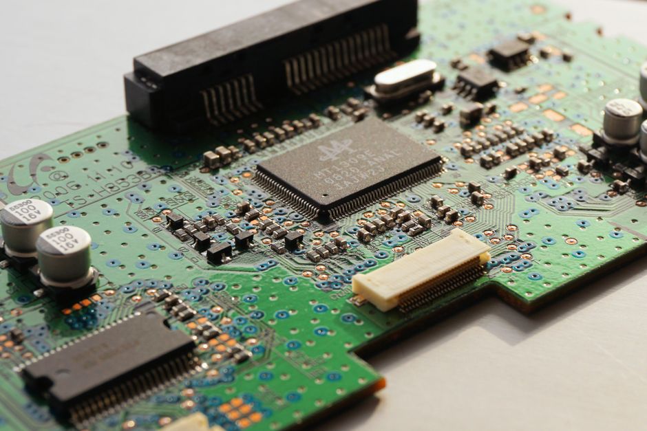Foto de primer plano detallada de una placa de circuito que destaca los componentes del microchip y los circuitos electrónicos.
