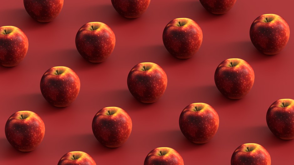 Un patrón repetido de manzanas rojas frescas dispuestas geométricamente sobre una superficie roja.