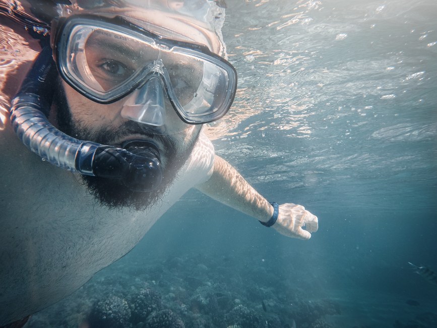 Hombre haciendo snorkeling bajo el agua en Egipto, mostrando exploración marina y aventura.
