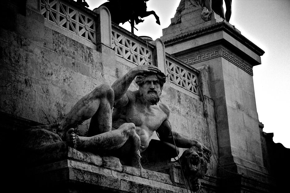 Foto en blanco y negro de una estatua dramática que captura la esencia histórica y la grandeza.