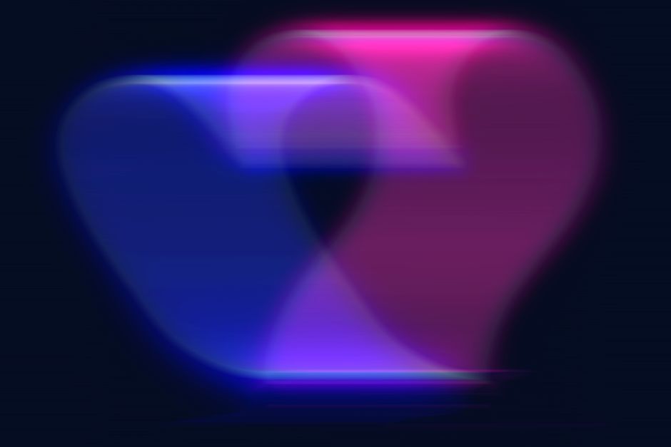 Una forma de corazón abstracta colorida en vibrantes colores neón con un efecto de movimiento borroso.