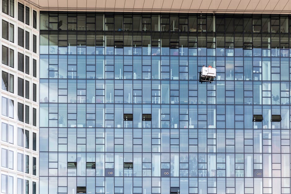 Exterior de un edificio de cristal de gran altura con limpiadores de ventanas en Hamburgo, Alemania.