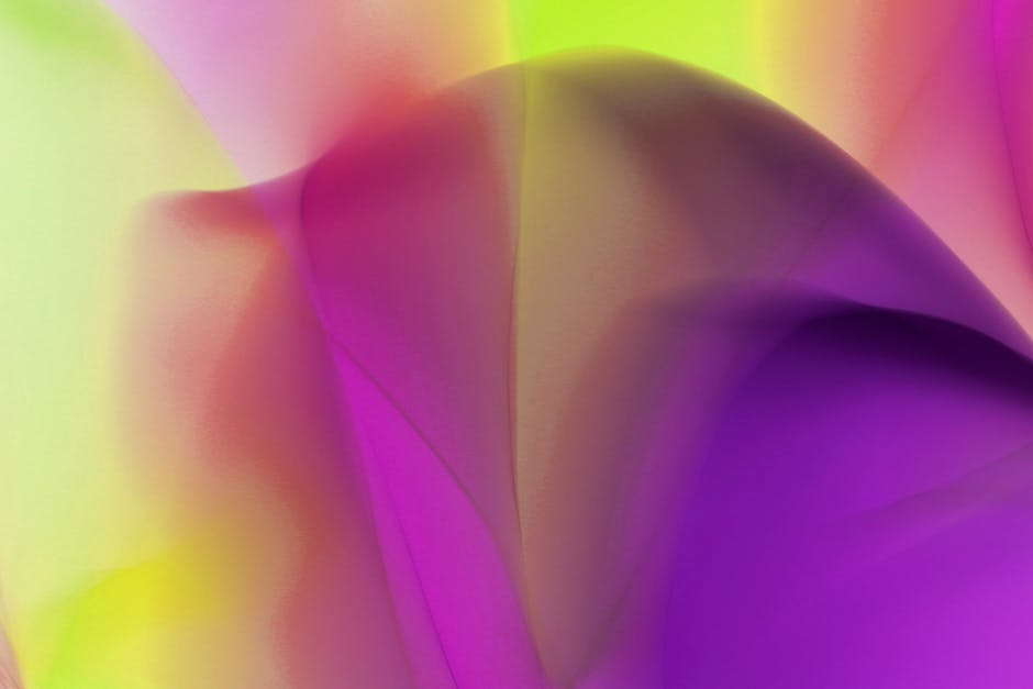 Arte abstracto colorido con formas fluidas y tonos vibrantes que crean un efecto visual dinámico.