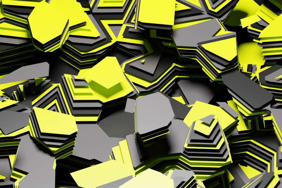 Imagen abstracta dinámica de formas superpuestas de color amarillo y gris que crean un patrón geométrico vívido.