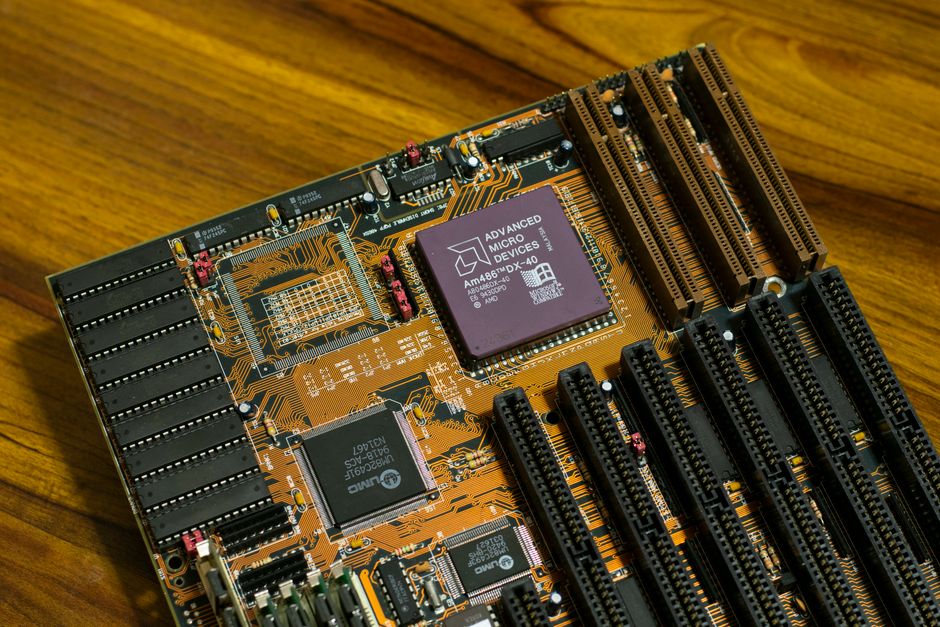 Primer plano de una placa base AMD vintage que presenta el procesador AM486 DX, mostrando la tecnología de computación retro.