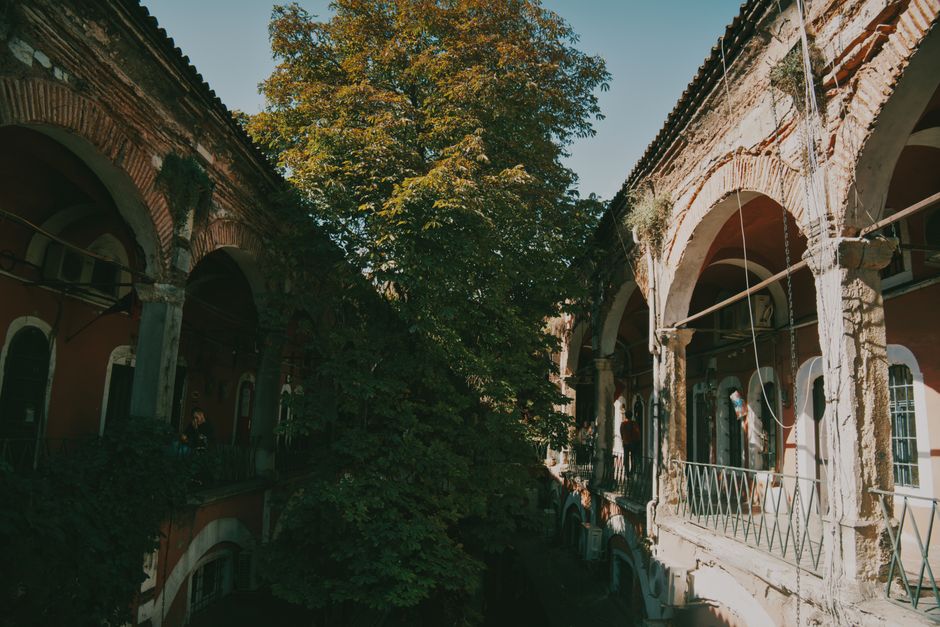 Un día soleado en un patio histórico con una arquitectura clásica de arcos.