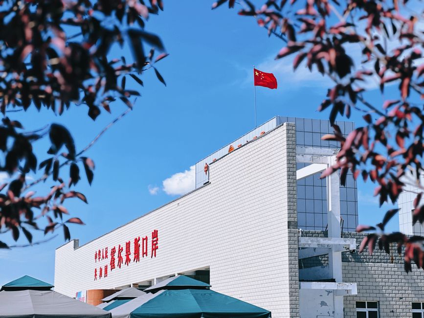 Una vista del Puerto de Korghos con la bandera china en un día soleado.