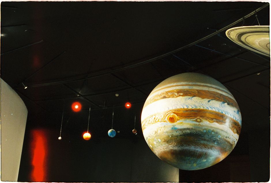 En un museo de ciencias se exhibe un modelo del sistema solar con planetas.